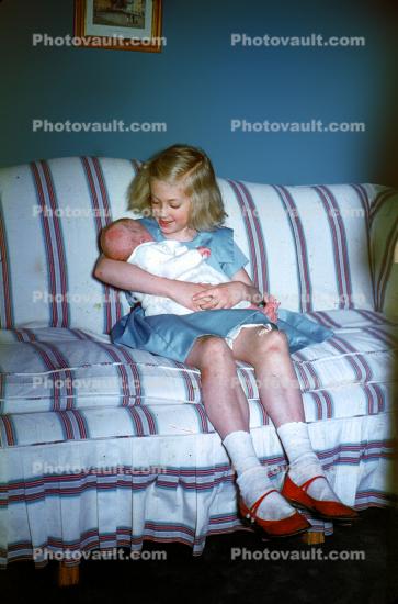 Girl Cuddles a Baby, 1950s