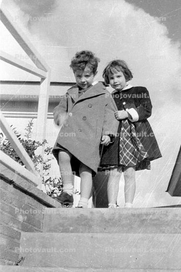 Girls, coats, steps, Molly and Terry, 1950s