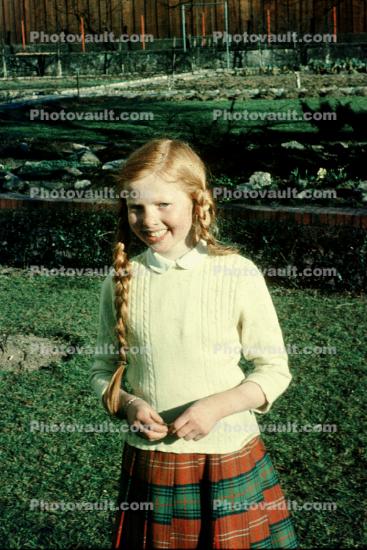 Smiling girl, Pigtails, sweater, 1950s