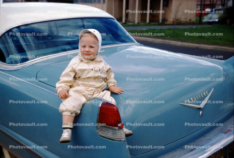 Baby on the tailfin of a Cadillac Car, 1950s