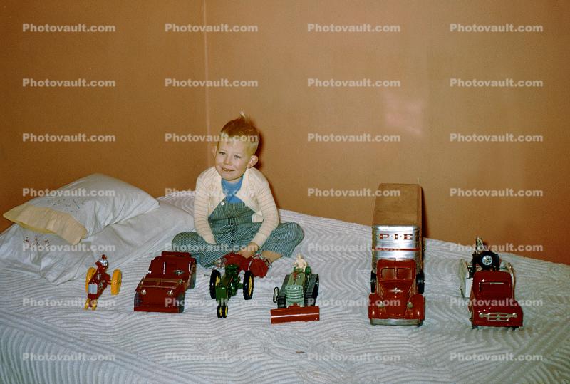 Boy and his toy cars, Jeep, tractor, PIE Express, Bed, collection, 1950s