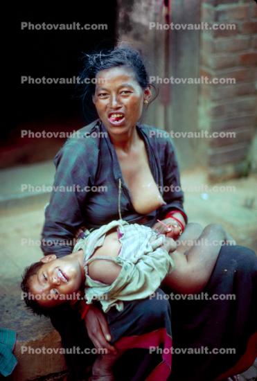 Woman nursing her baby, In the Himalayas in Nepal, Araniko Highway