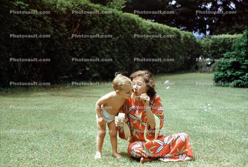 Toddler Blowing bubbles, Boy, Backyard, 1950s