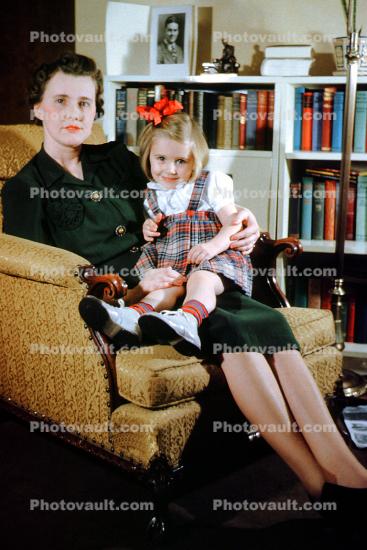 Mother with Daughter sitting on a chair, woman, girl, hair ribbon, 1940s