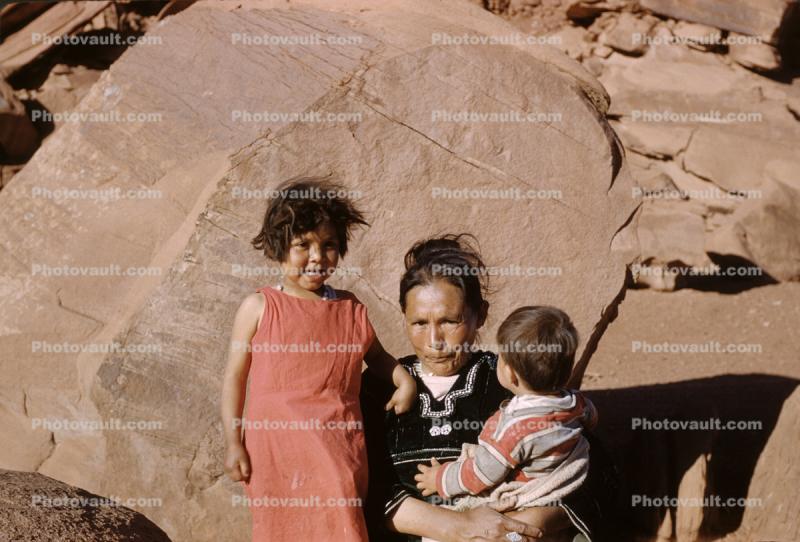 Navajo Woman with Babies, sandstone boulders, Sand, Desert