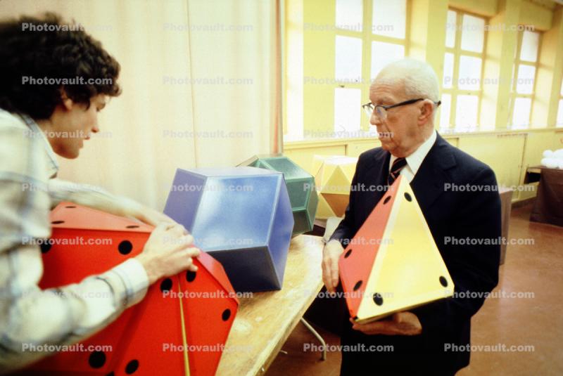 Icosahedron, Tetrahedron, Bucky preparing polyhedra models, "Conversations with Buckminster Fuller" event, Oakland, Polyhedra