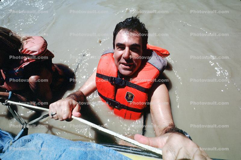 Max the Lawyer floats in the muddy river, Colorado River, raft trip