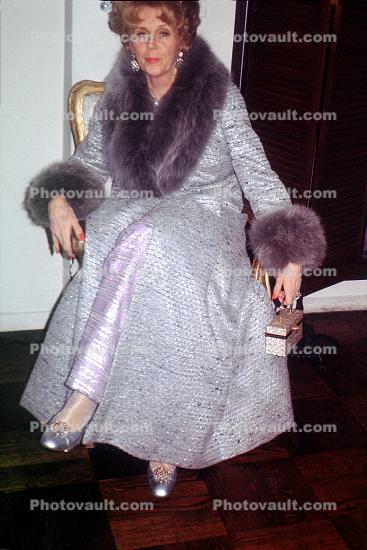 Woman sitting, fur coat, formal