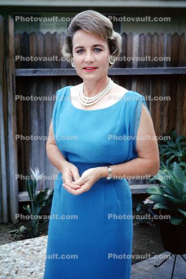 Lady with a blue dress on, necklace, smile, August 1964, 1960s