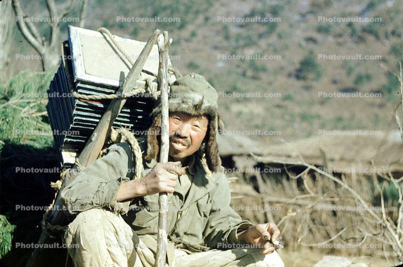 Korean man, smiles, backpack, near Pusan, South Korea, January 5 1952, 1950s