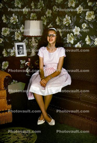 Teen Girl sitting on a Sofa, Cateye Glasses, February 1964, 1960s