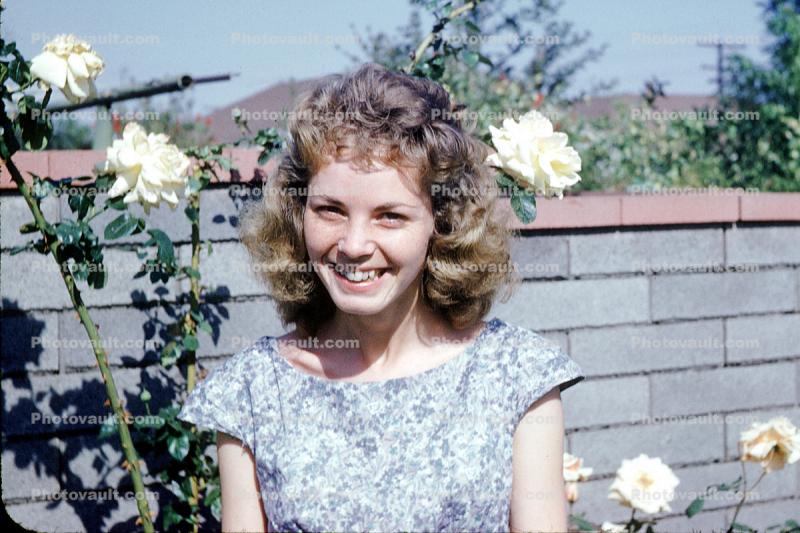 face, women, young, female, smiles, friendly, dress, roses, brick fence, 1960s