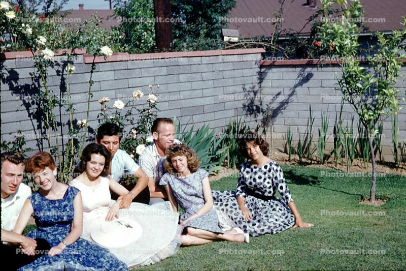 Women, girls, backyard, trees, roses, 1950s
