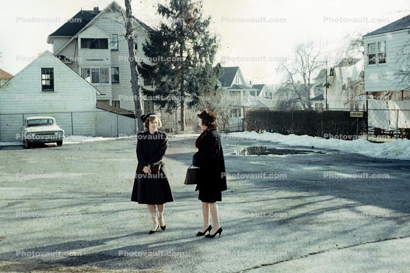 Women, coats, cold, hats, high heels, buildings, 1950s