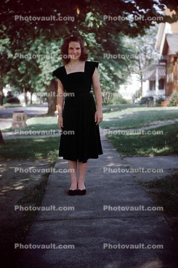 Pretty lady on a sidewalk, 1960s
