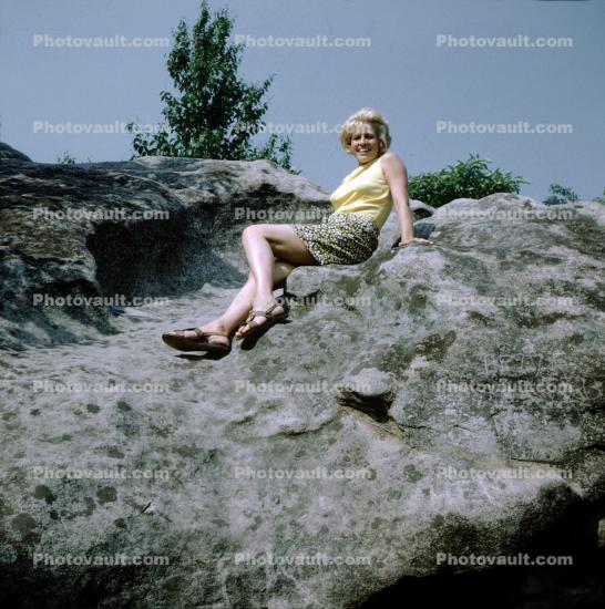Woman sitting on a rock, 1970s