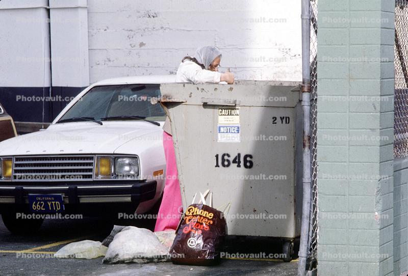 Woman Digs Thourhg a Trash Bin, Dumpster, Homeless