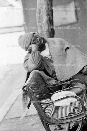 Sleeping Homeless man on a Bench