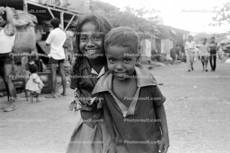 Girl smiles, boy smiling, shanty town, slum, Mumbai, India