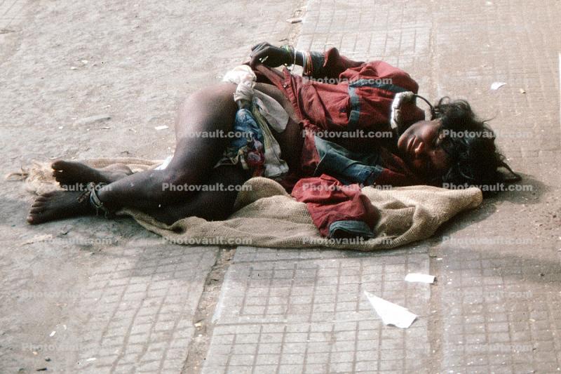 Woman lying in Pain, Crying, suffering, dying, Mumbai, India