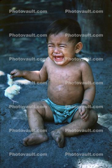 Crying Child with a baby chick, Tears, San Salvador