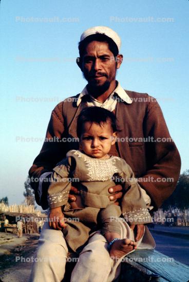 Father, daughter, girl, barefoot, Refugee Camp, Pakistan