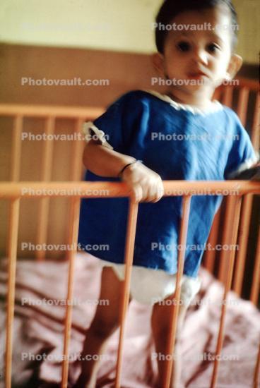 Child standing in a crib, Mother Teresa Convent