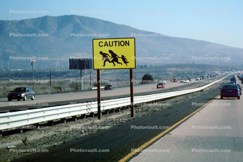 Caution Illegal Immigrant Crossing, Road sign, cars, Interstate Highway I-5, warning, Camp Pendalton, running, people
