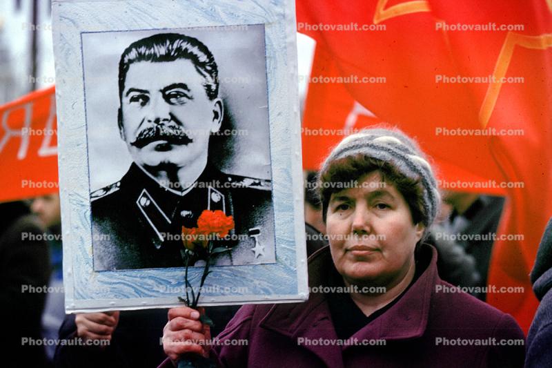 Woman holding up Stalin Poster, Pro Communism Rally, Moscow, Russia