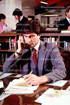 Busy office, workers, employees, phone, desk, many people, traders, brokers, stocks and bonds, 1984, 1980s, businessman