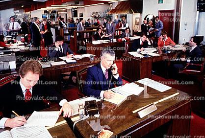 Busy office, workers, employees, phone, desk, many people, traders, brokers, stocks and bonds, 1984, 1980s, businessman
