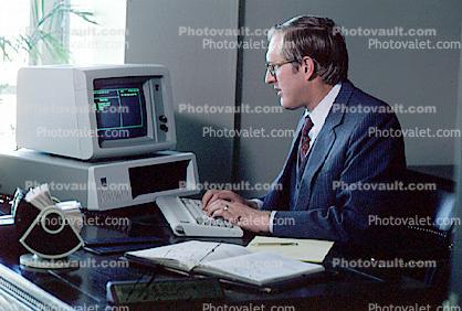 IBM computer, Businessman, Gold Trader, gems, Office, worker, employee, desk, people, broker, stocks and bonds, person, man, rolodex, calendar, 1984, 1980s