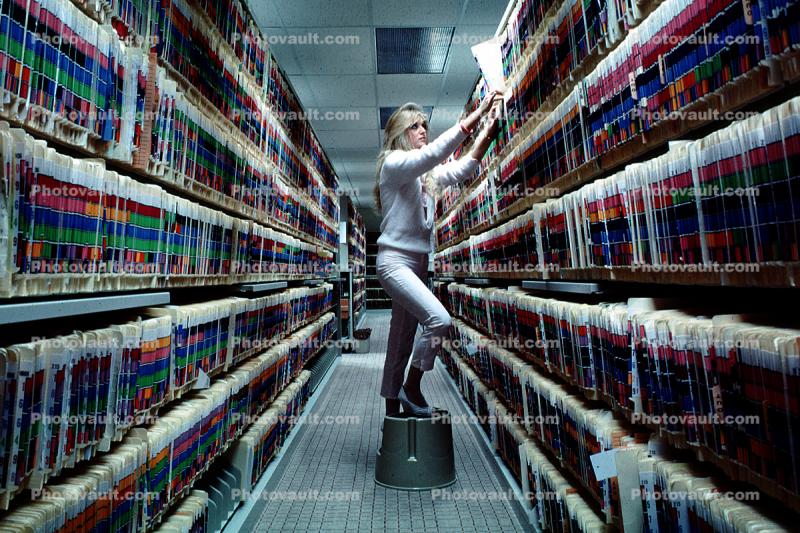 Records Hall, Record Keeping, Files, Woman, Retrieval, Hall, Racks, Folders, File Folders, Paper Rows, paperwork, bureaucracy, archive, clutter, documents, dossier, workers, vanishing point, 1980s