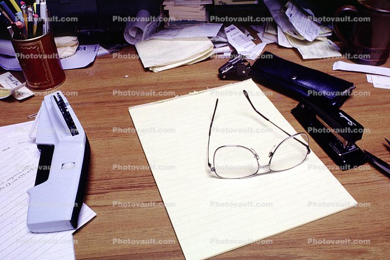 Desk glasses, paper, messy