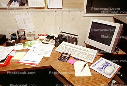 calculator, keyboard, radio, clutter, radio, cordless phone, desk, paperwork, rolodex