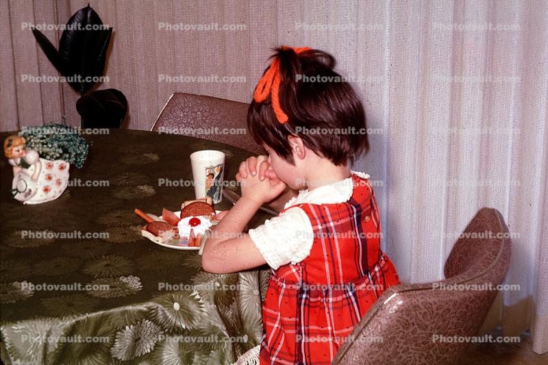 Girl saying grace, prayer, praying, female, food, 1960s