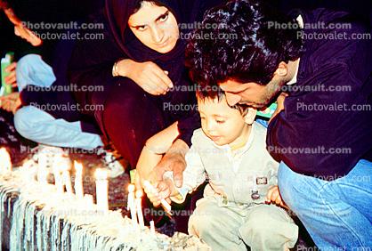 Boy lighting a Candle, man, male, female, woman, mother, father, son
