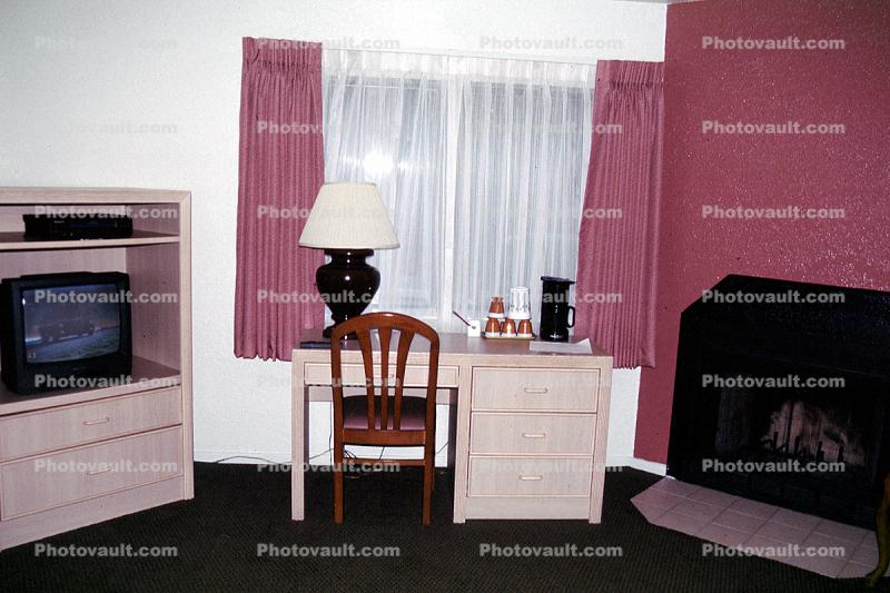 Television, desk, lamp, fireplace, curtain, chair