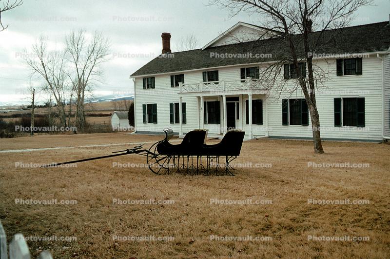 Sled, Bare Tree, Winter, Building, Lawn, south of Dillion Montana