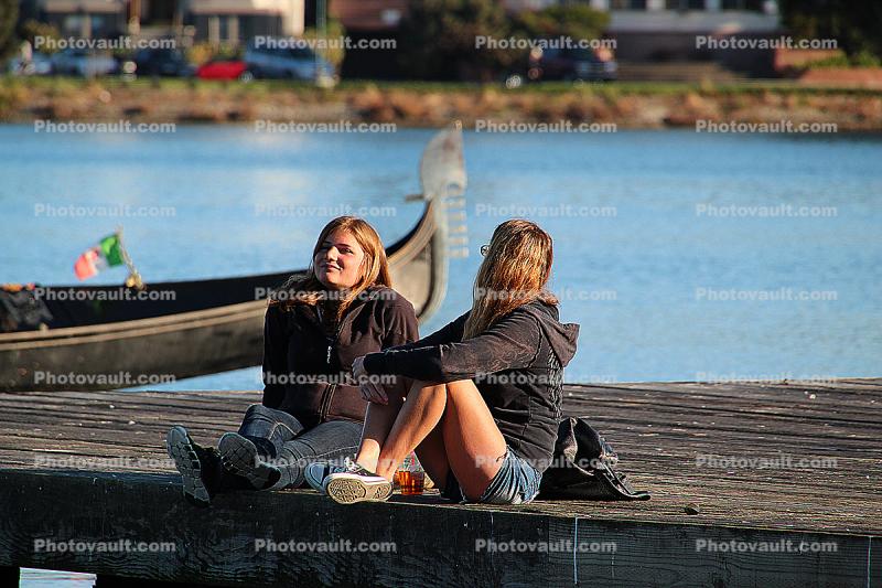 Two Girls Sitting on a Dock