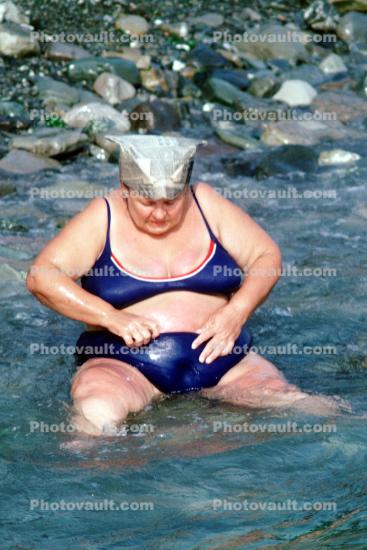 Overweight Lady sitting in the water at Sochi Russia