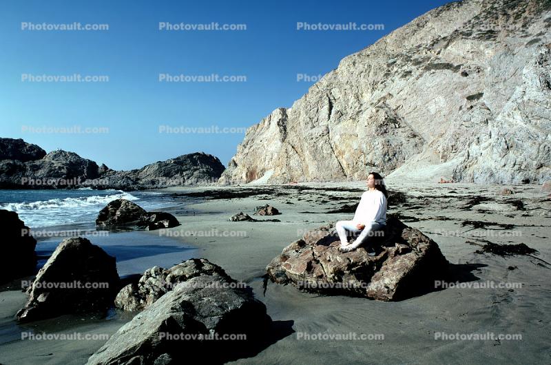 Woman Meditating at the Beach, water, rocks, sand