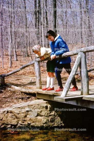 Girls on a footbridge, friends, wooden bridge, stream, woodland, 1964, 1960s