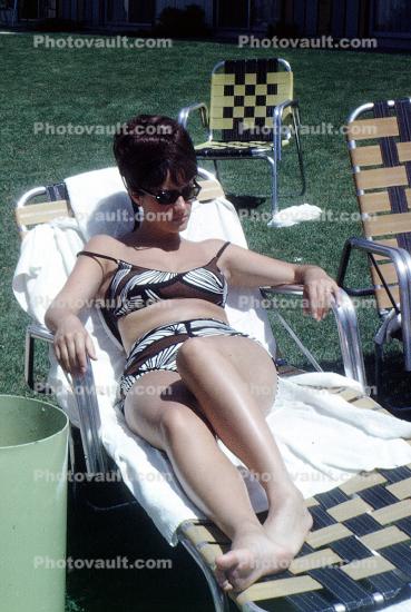 Woman relaxing on a lounge chair, Beehive Hairdo, hairstyle, 1950s
