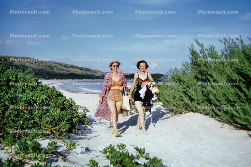 Women walking in the sand, Horseshoe Beach, Hamilton, Bermuda, 1950s