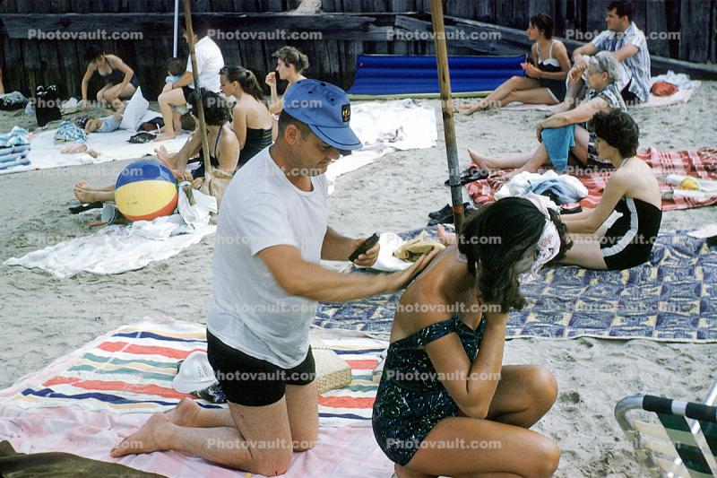 Applying sun tan lotion, Buckroe Beach, Hampton, Virginia, 1960s