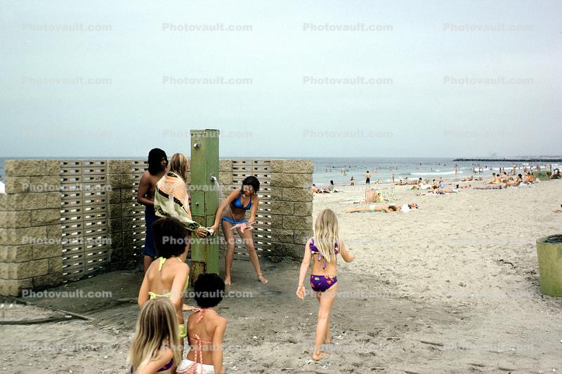 Shower, Beach, Sand, Girl washing off a starfish, 1974, 1970s