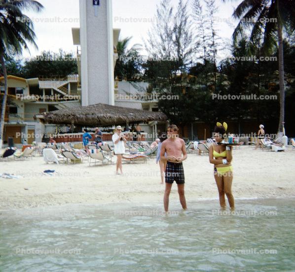 Woman, Man, beach, water, wading, Cayman Islands, 1966, 1960s