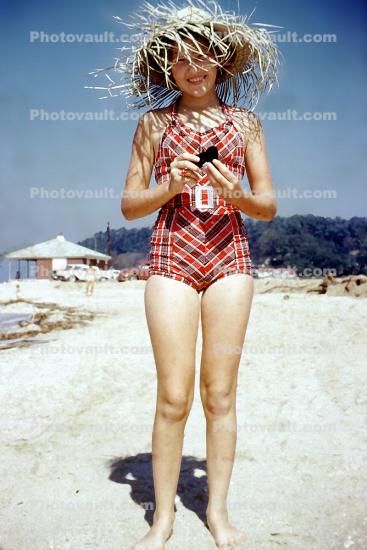 Girl on a beach, Suntan, sunburn, sun exposure, summer, hot, heat, summery, sunny, hat, 1950s