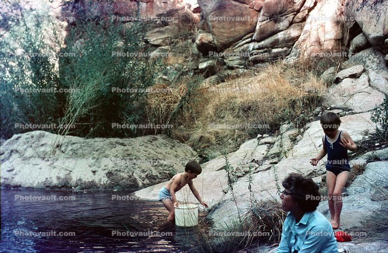 Playing by a stream, girl, boy, woman, bathingsuit, 1969, 1960s